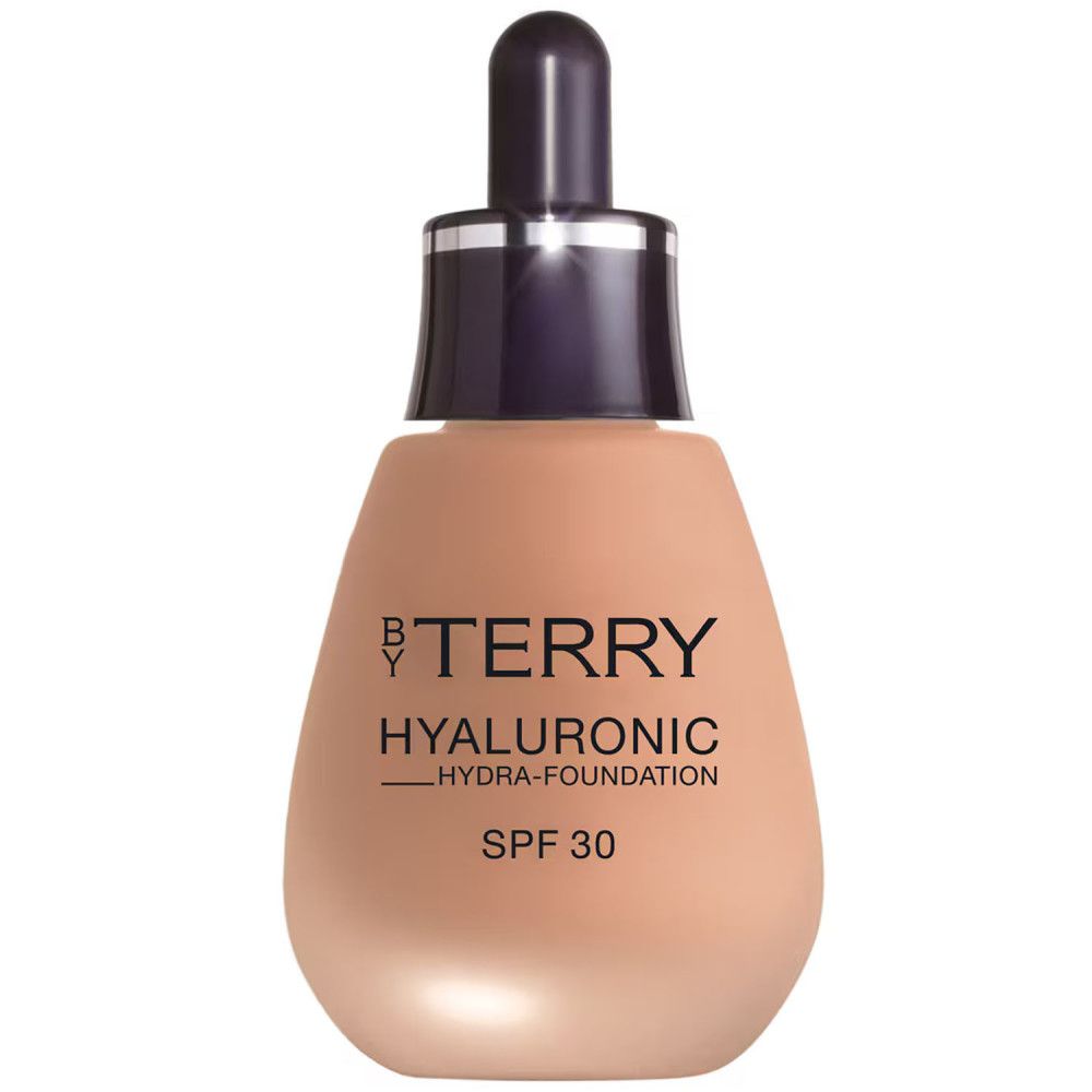 Beige foundationflesje met zwarte dop en pipet. Opschrift: BY TERRY HYALURONIC HYDRA-FOUNDATION SPF 30.
