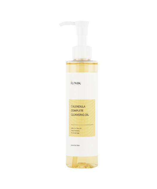 Flacon transparent avec pompe. L'étiquette indique "IUNIK Calendula Complete Cleansing Oil".