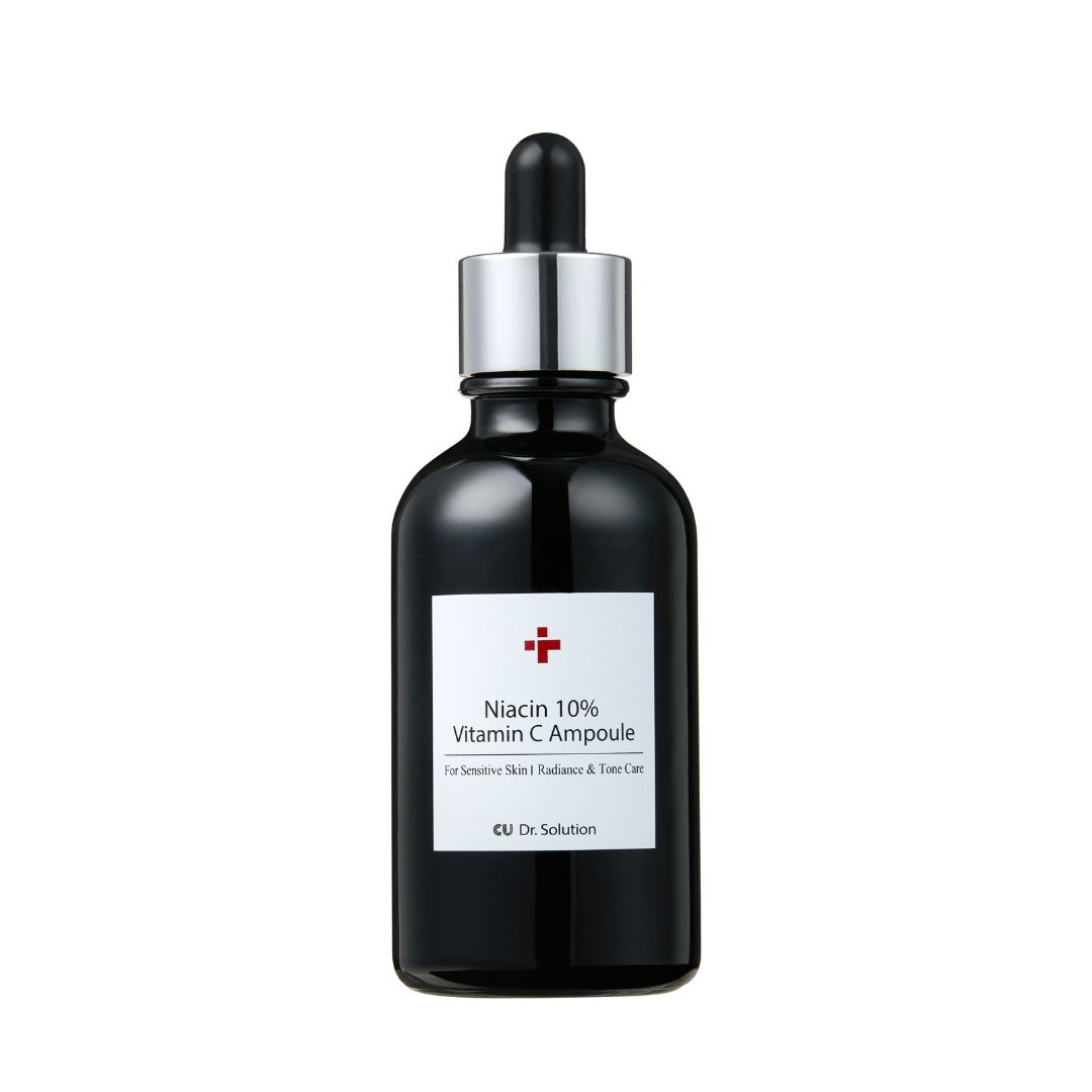Zwarte glazen fles met pipet. Etiket met rood kruis en tekst: Niacin 10% Vitamin C Ampoule. Voor gevoelige huid.