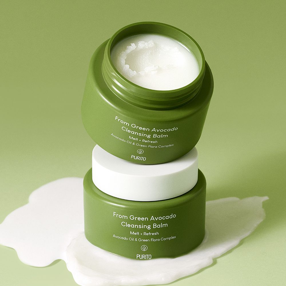 Deux pots verts empilés l'un sur l'autre, avec couvercle blanc et baume.