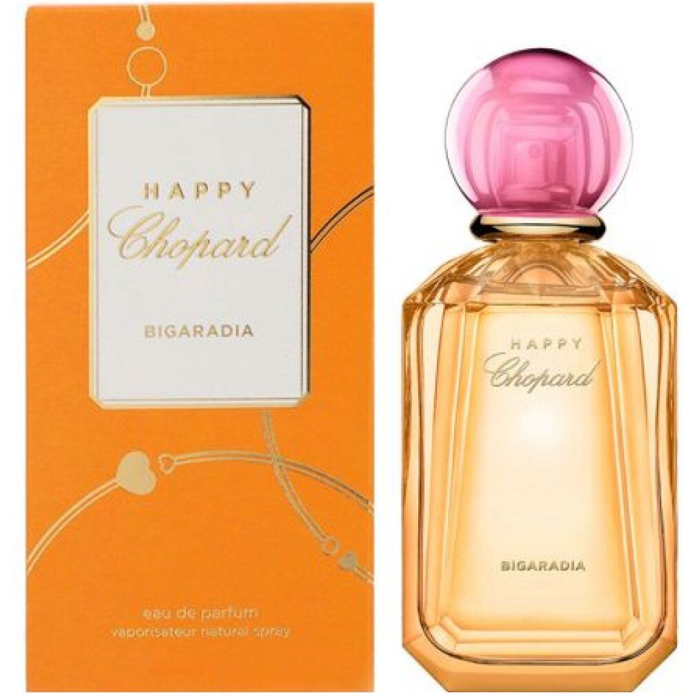 Parfumfles en verpakking. Fles met roze dop, goudkleurig glas. Oranje verpakking met wit etiket en opschrift Happy Chopard.