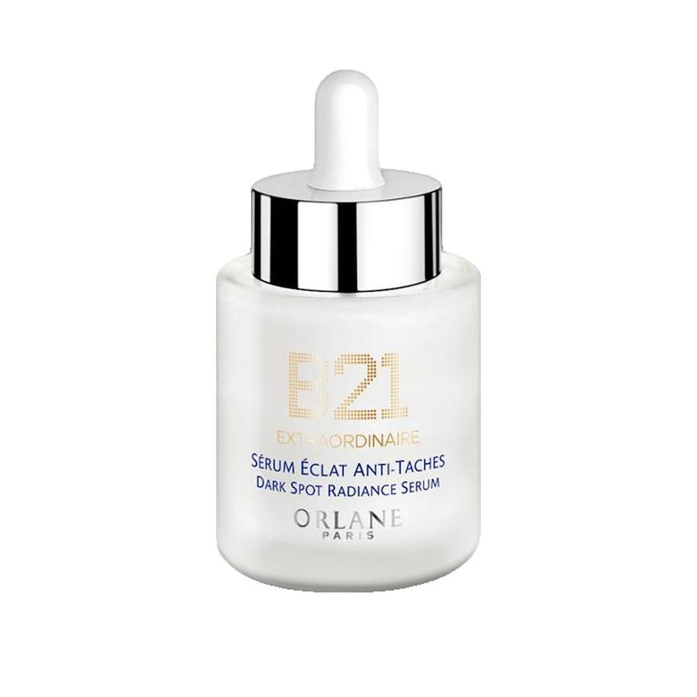 Flacon de sérum blanc avec bouchon argenté et pipette. Inscriptions : B21 Extraordinaire, Sérum Éclat Anti-Taches, Dark Spot Radiance Serum. Marque : Orlane Paris.