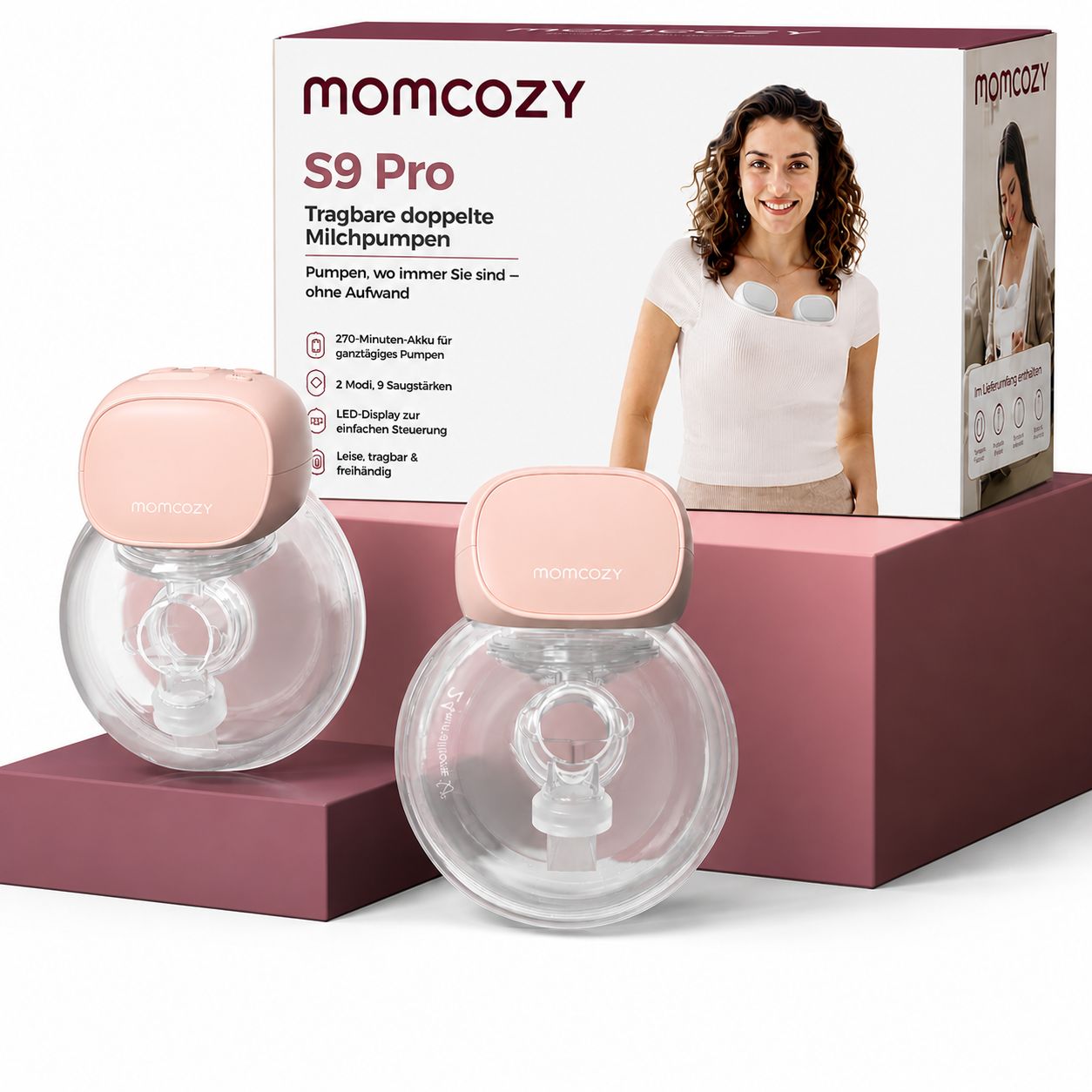 Deux tire-laits Momcozy S9 Pro roses avec récipients, à côté de l'emballage du produit.