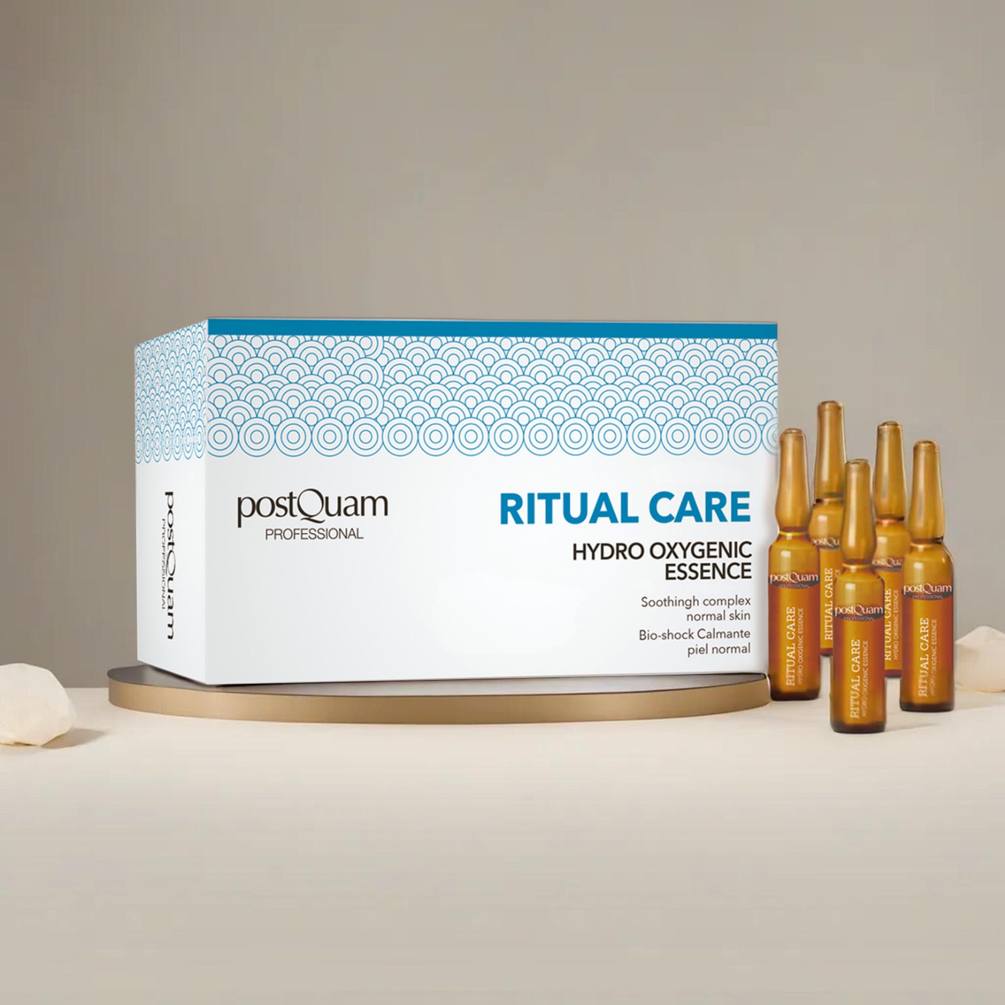 Verpakking met ampullen op een sokkel. Opschrift 'Postquam Professional', 'Ritual Care Hydro Oxygenic Essence'. Ampullen ernaast.