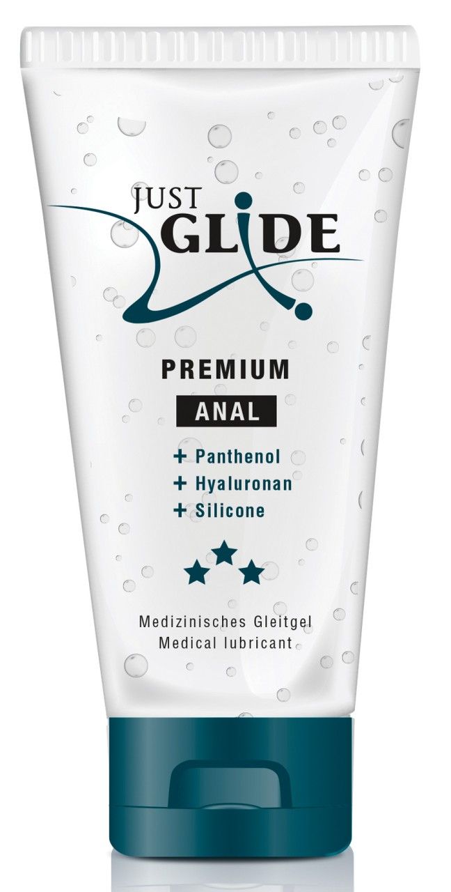 Tube transparent avec bouchon bleu. Inscription: Just Glide, Premium Anal, ingrédients. Étoiles et Medical lubricant.