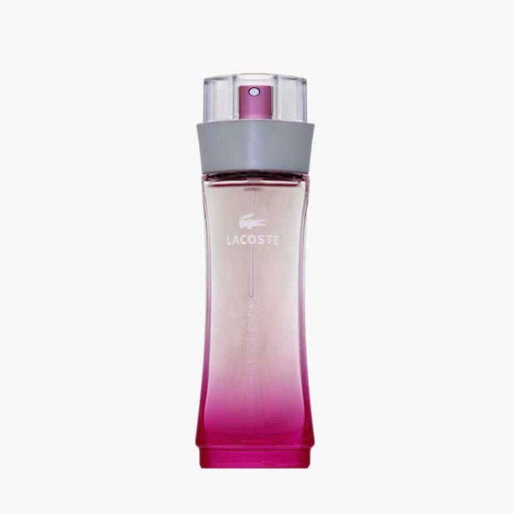 Lacoste Touch of Pink Eau de Toilette fles. Roze kleurverloop, grijze ring, transparante spraykop.