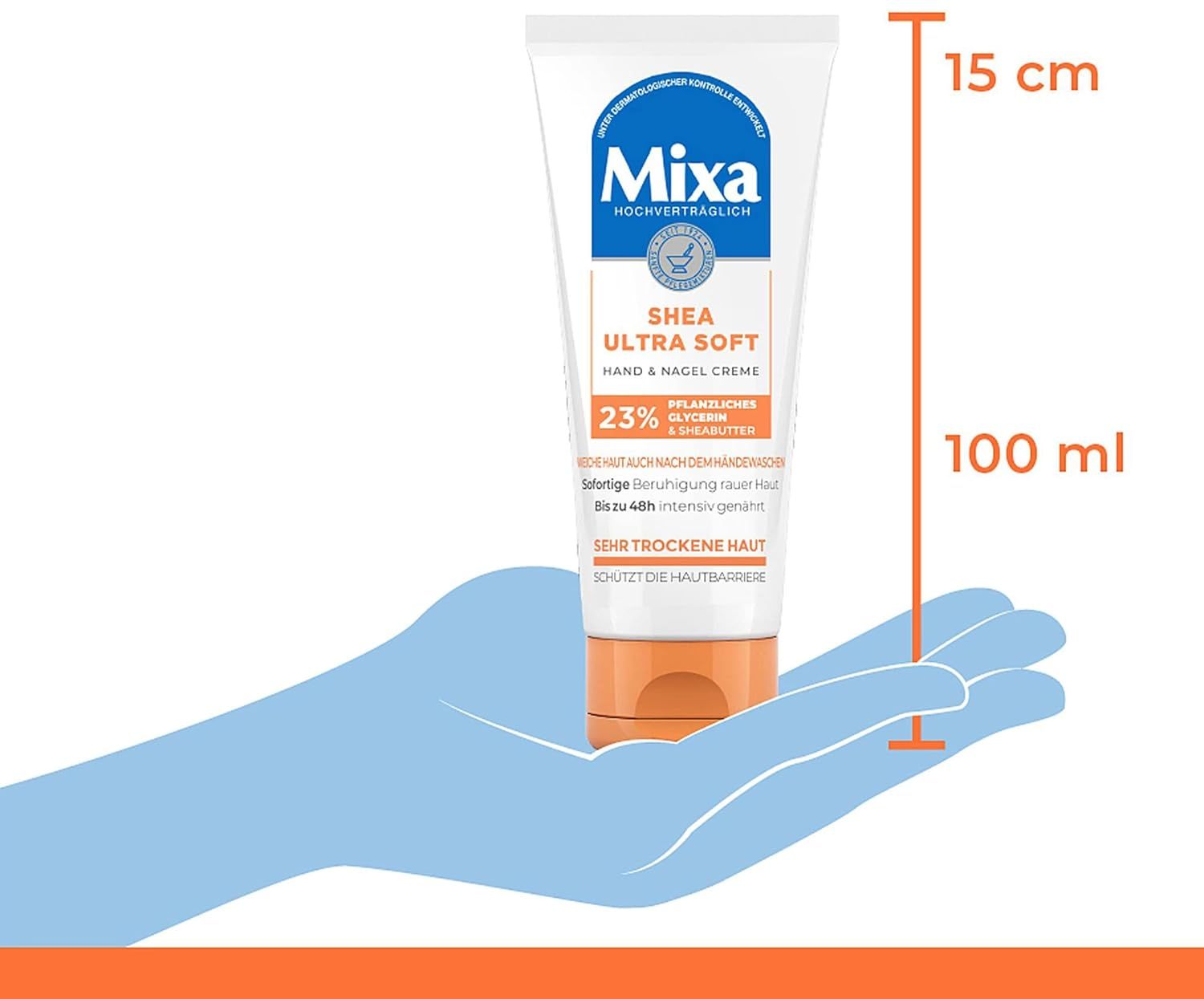 Main tenant un tube Mixa Shea Ultra Soft Hand & Nagelcreme. Dimensions: 15 cm de haut, 100 ml.