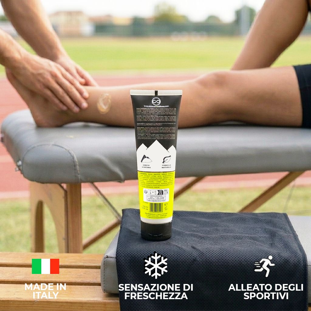 Tube "Arnica 98% Estrema" sur une civière à côté d'une jambe massée.