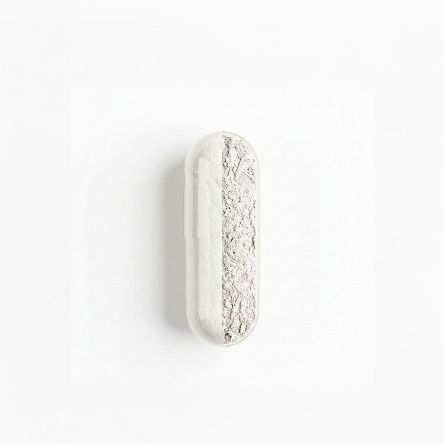 Une capsule contenant une poudre blanche, divisée en deux moitiés.