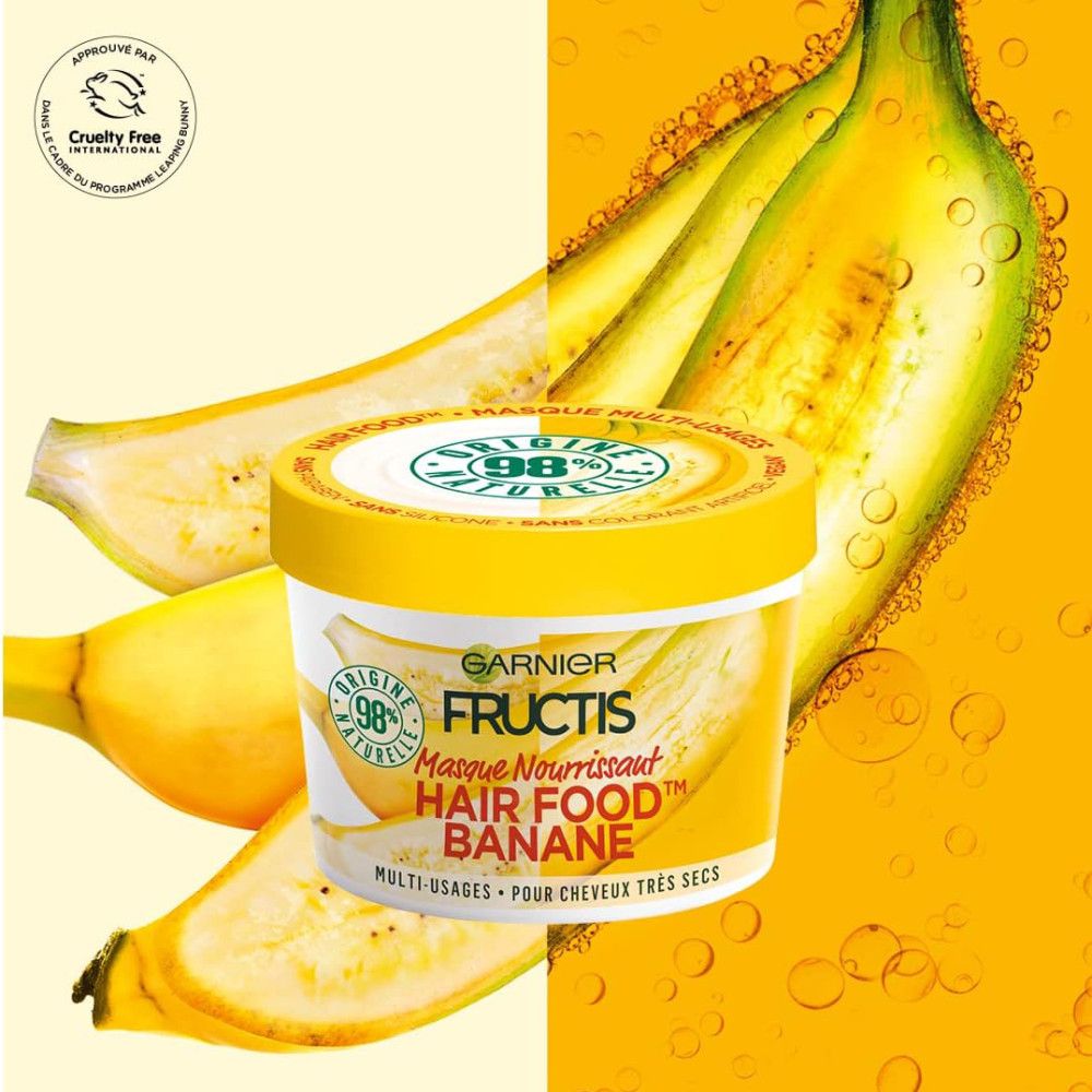 Pot jaune Garnier Fructis Hair Food Banane. Inscription: Masque Nourrissant. Illustrations de bananes. Logo Cruelty Free.