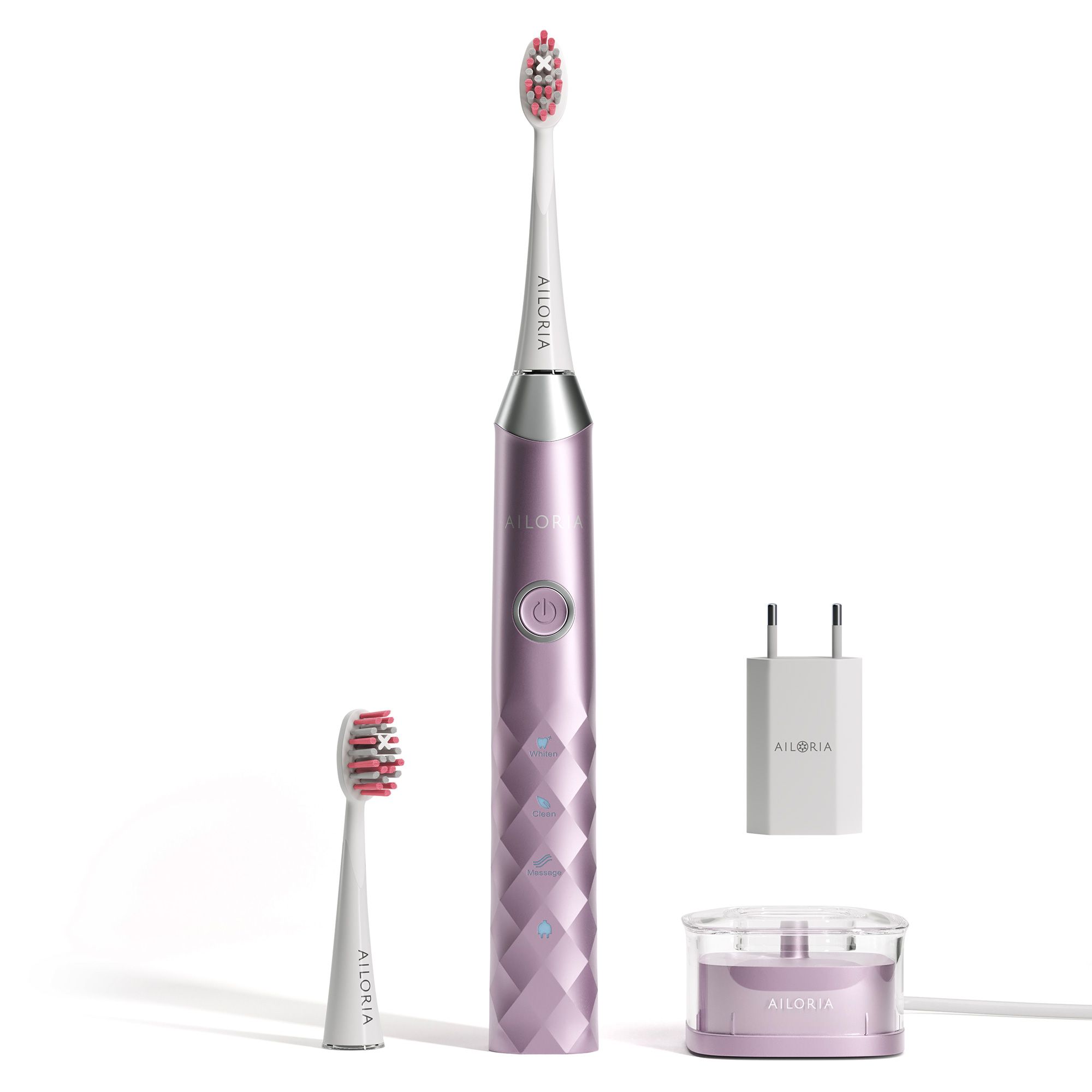 Roze elektrische tandenborstel, accessoires. Oplaadstation, reserve opzetborstel en voedingsadapter.