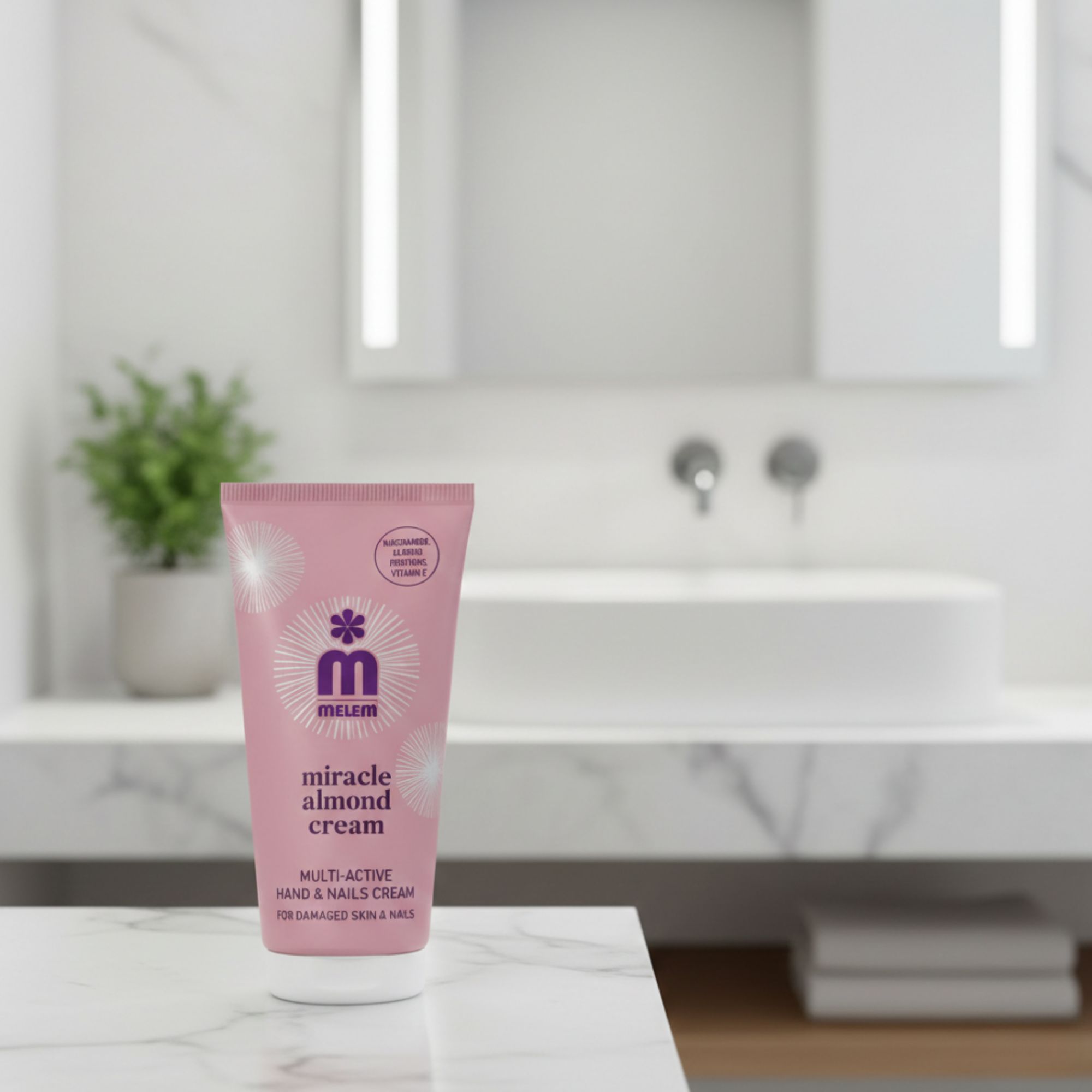 Roze tube "melem miracle almond cream" op marmer. Tekst: Multi-Active Hand & Nails Cream. Voor beschadigde huid & nagels. Met amandelolie.