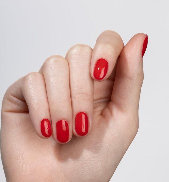 Main avec ongles vernis. Couleur : N22 Red Velvet. Finition brillante. Tous les ongles sont vernis.