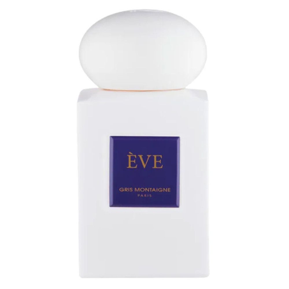 Flacon blanc avec bouchon rond. Étiquette bleue avec "ÈVE" et "Gris Montaigne Paris".