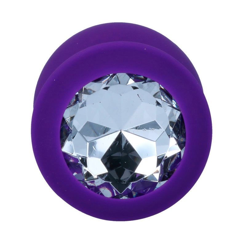 Gros plan d'un plug anal violet avec décoration en cristal.