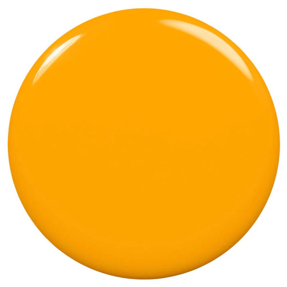 Tache de vernis à ongles jaune. Forme ronde, surface brillante.