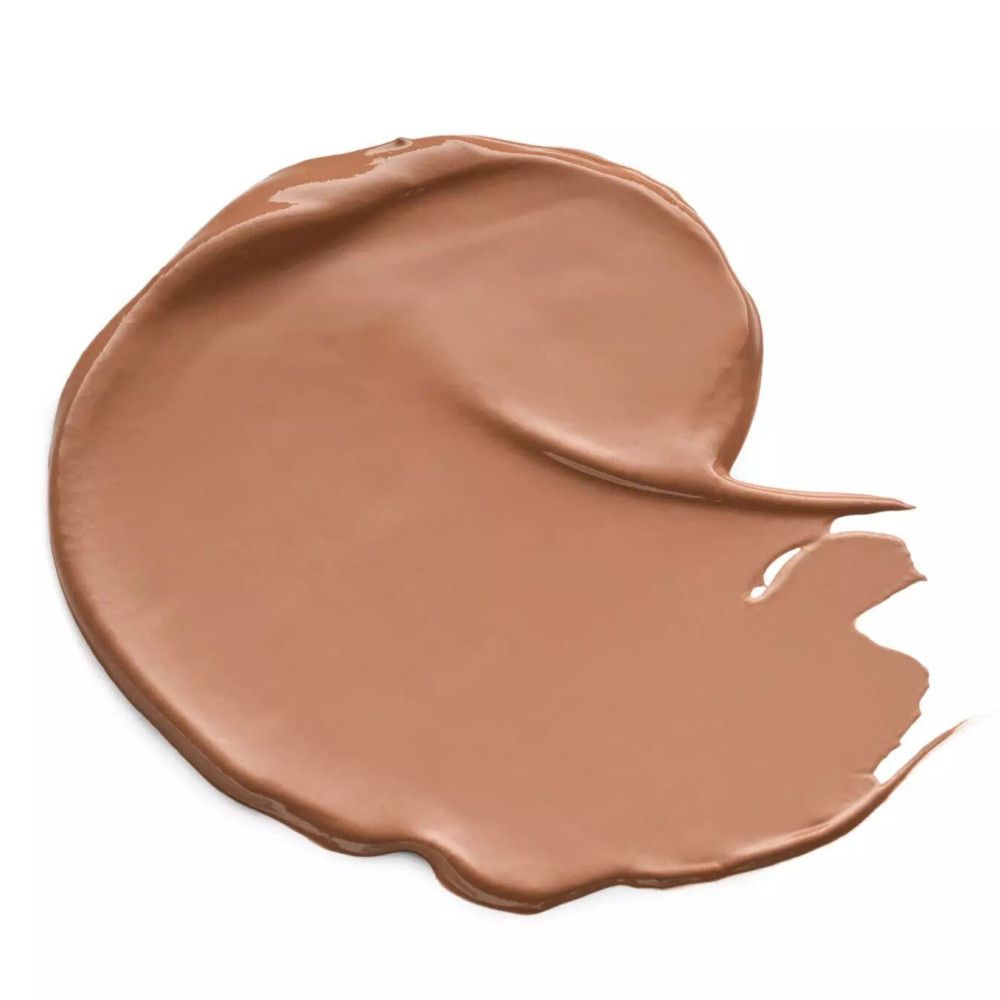 Échantillon de correcteur brun sur fond blanc. Texture visible.