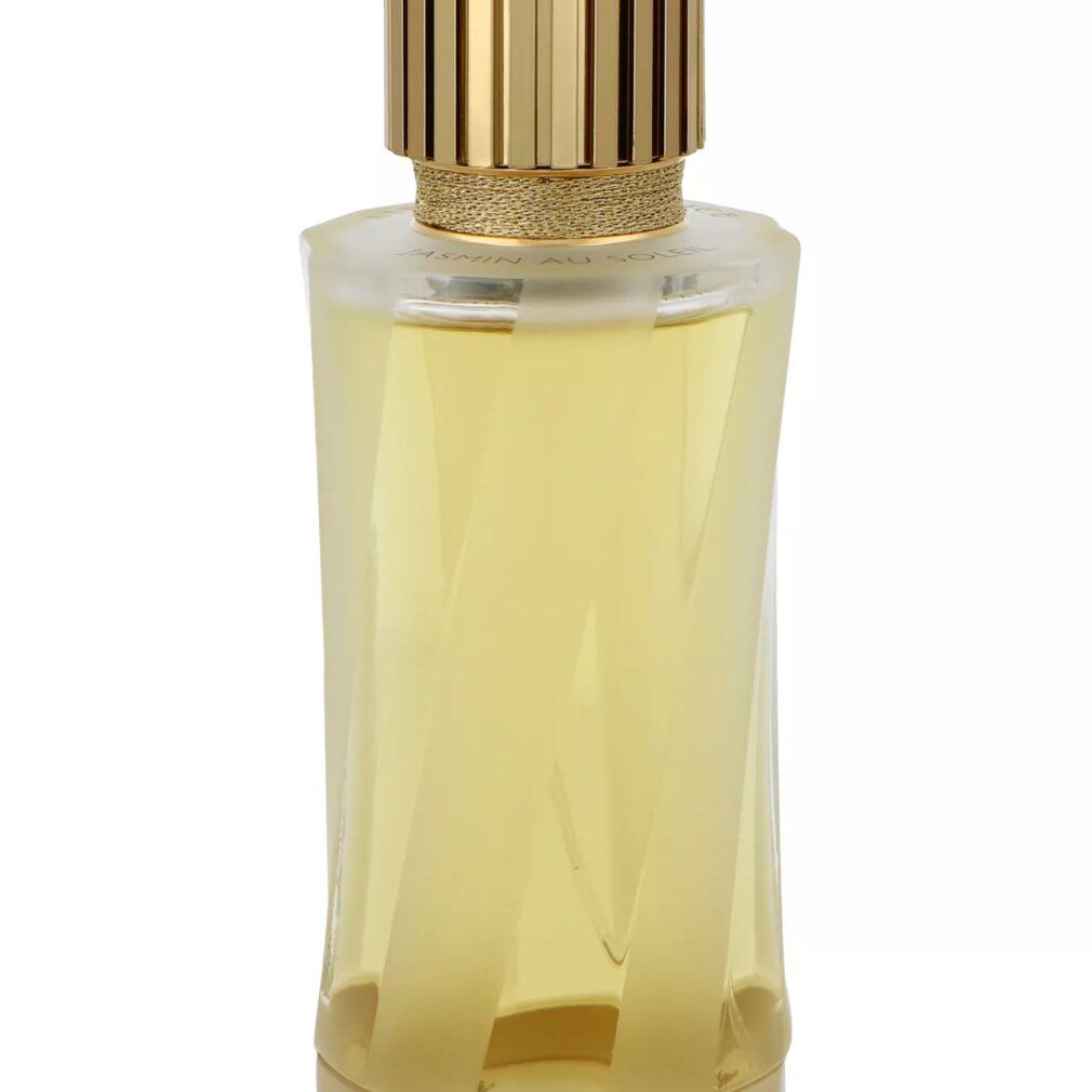 Flacon de parfum avec bouchon doré et design géométrique.