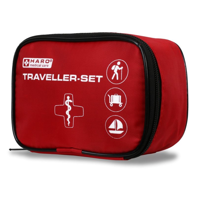 Rode EHBO-tas met zwarte rits. Opschrift: HARO medical care, TRAVELLER-SET. Symbolen: wandelaar, koffer, zeilboot.