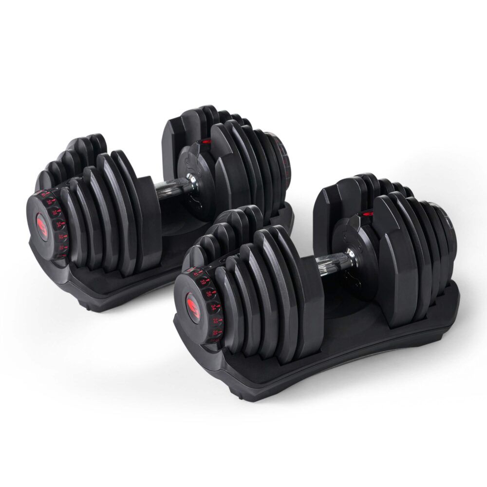 Twee zwarte dumbbells met rode accenten. Elke dumbbell heeft een ronde, verstelbare gewichtsschijf en een basis.