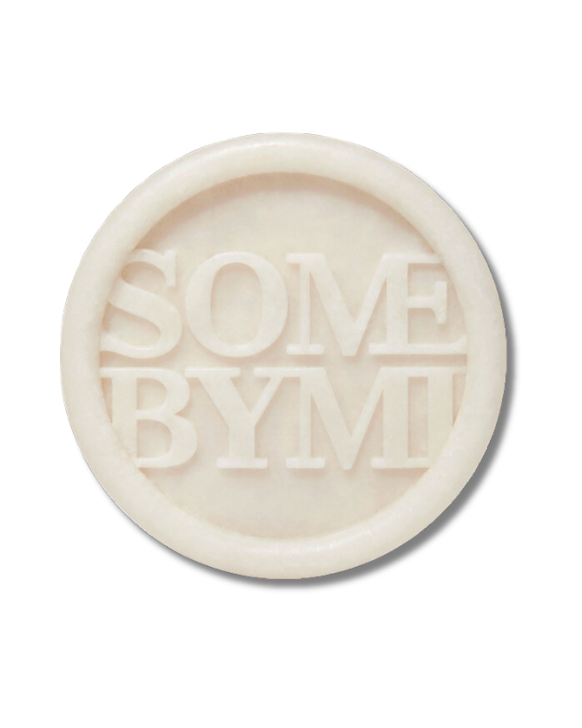 Savon rond avec le texte SOME BYMI dans un cercle.