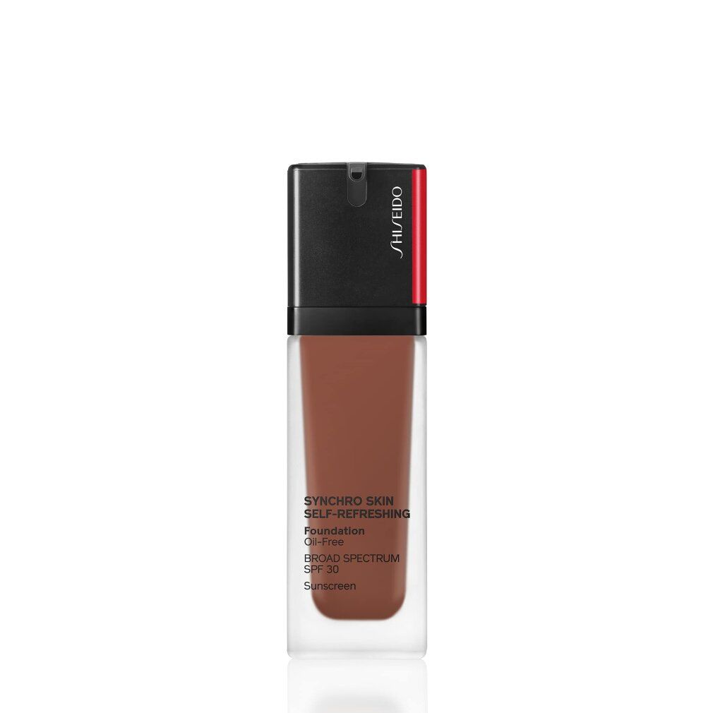 Fond de teint liquide en flacon de verre. Bouchon noir avec accent rouge. Texte: Synchro Skin, SPF 30, sans huile.