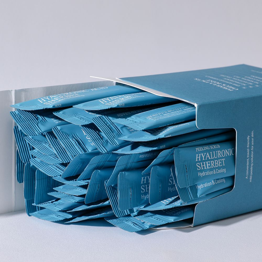 Open verpakking van MIZON Hyaluronic Acid Sherbet Peeling Scrub. Veel individuele verpakkingen. Tekst: Hyaluronic Acid Sherbet.
