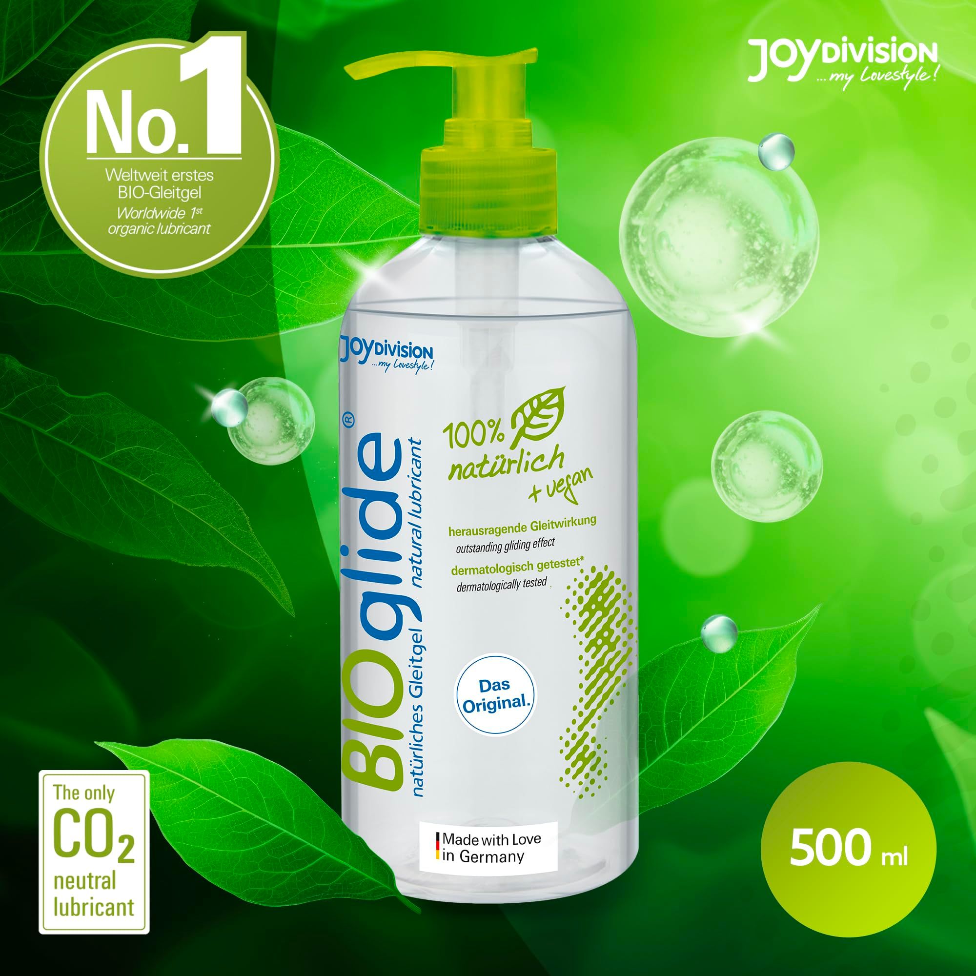 Fles BIOglide glijmiddel met pompdos, omringd door groene bladeren en bubbels.