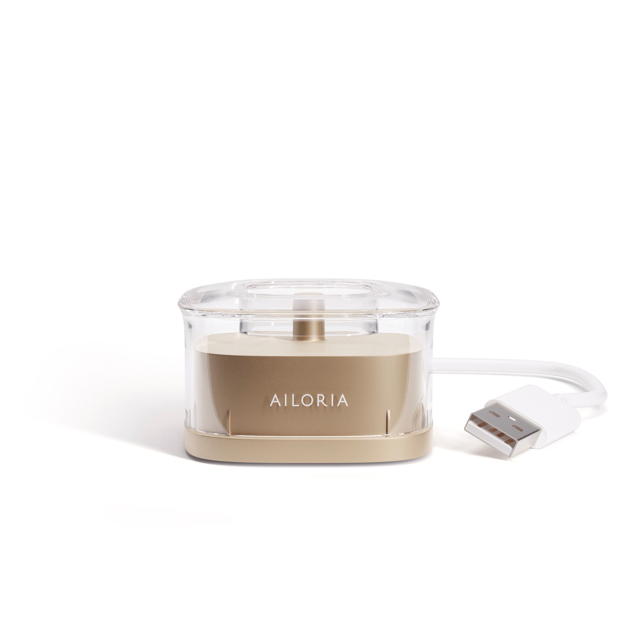 AILORIA inductief laadstation. Goudkleurige behuizing met transparante deksel. USB-kabel met witte stekker.