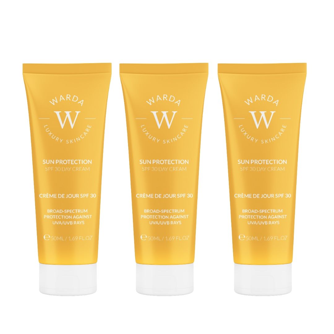 Trois tubes jaunes avec bouchons blancs. Inscription: Warda Luxury Skincare, Sun Protection SPF 30 Day Cream.