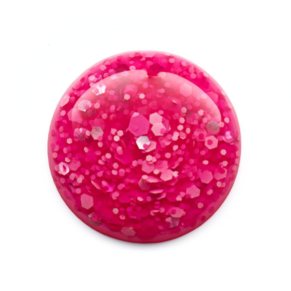 Vue de dessus du vernis à ongles rose avec des paillettes.