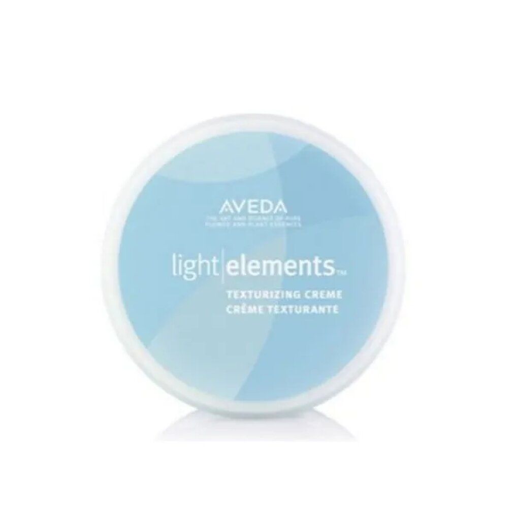 Récipient rond bleu avec couvercle blanc. Inscription: Aveda light elements. Crème texturisante. Crème texturisante.