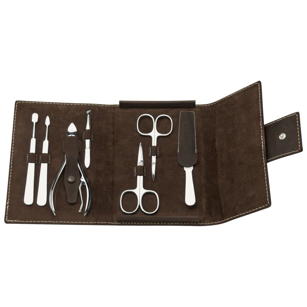 Open bruin lederen etui met manicuregereedschap. Bevat schaar, vijl, pincet, etc.