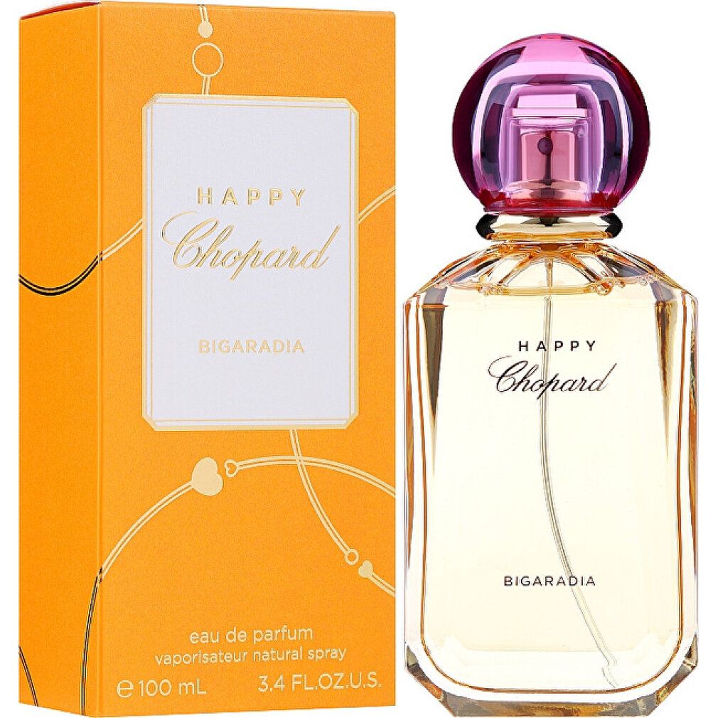 Parfumfles en verpakking. Fles met roze dop, goudkleurig glas. Oranje verpakking met wit etiket en opschrift Happy Chopard.