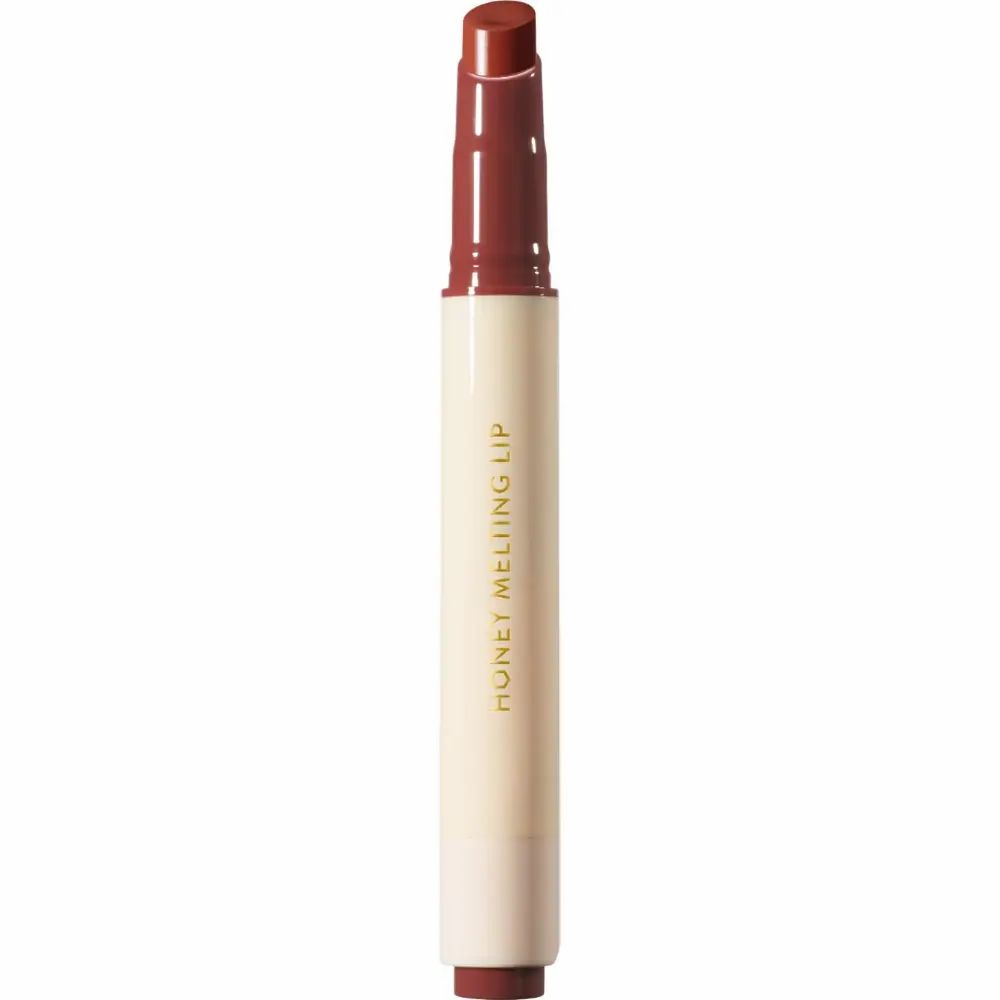 Lipgloss-stift. Beige-witte huls met bruine lipgloss. Opschrift: HONEY MELTING LIP.