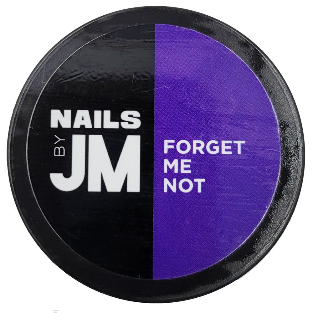 Contenant rond, divisé en noir et violet. Le côté noir porte "NAILS BY JM". Le côté violet porte "FORGET ME NOT".