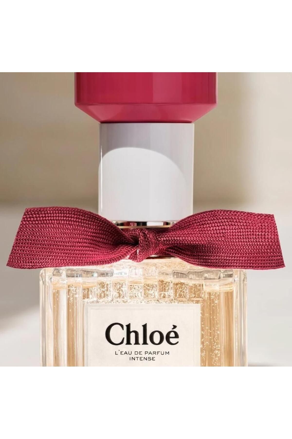Flacon en verre avec nœud rouge. Inscription: Chloé L'Eau de Parfum. Le flacon est partiellement rempli.