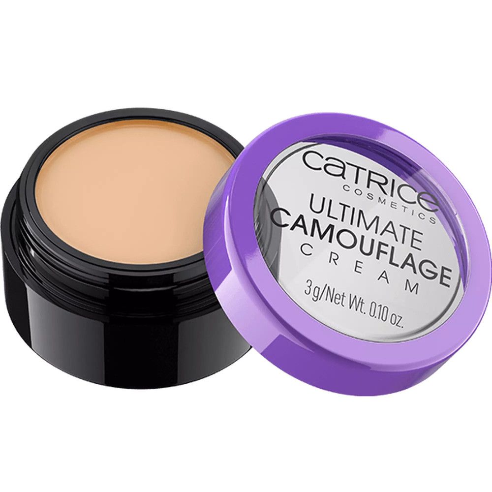 Correcteur en pot noir avec couvercle violet. Inscription: Catrice Ultimate Camouflage Cream. Contenu: 3g/Net Wt. 0.10 oz. Couvercle à côté.