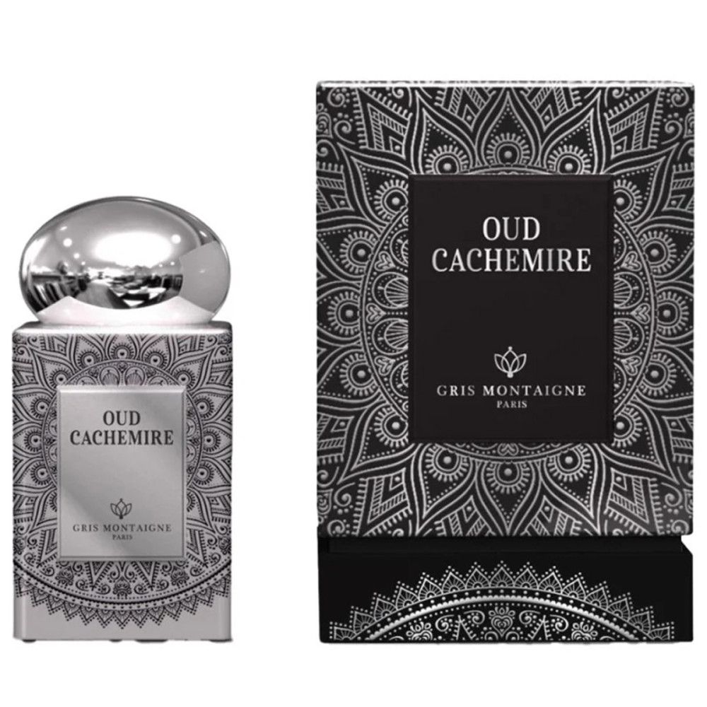 Flacon de parfum et boîte. Flacon argenté avec bouchon. Écriture noire Oud Cachemire. Gris Montaigne Paris.