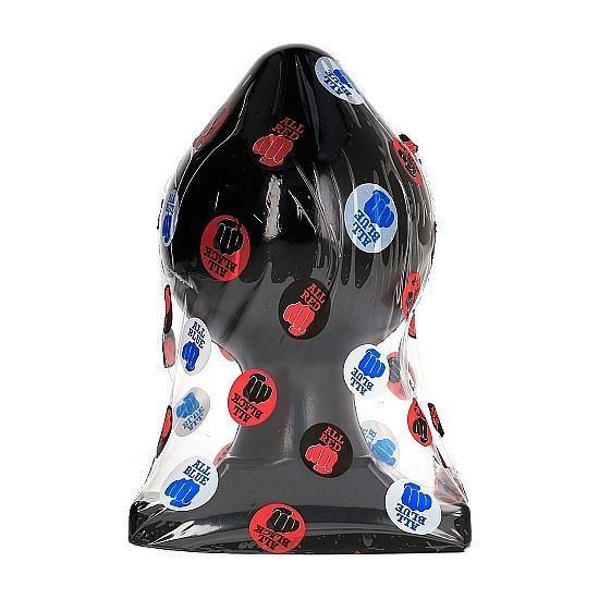 Zwarte anale plug in folie, bedekt met ronde stickers.