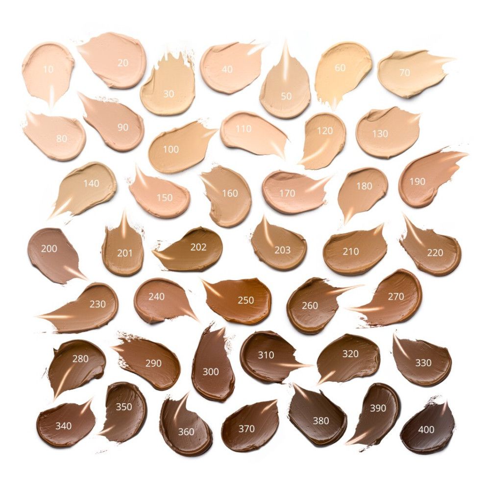 Échantillons de fond de teint sur fond blanc. Différentes nuances en forme de traits. Sélection de couleurs.