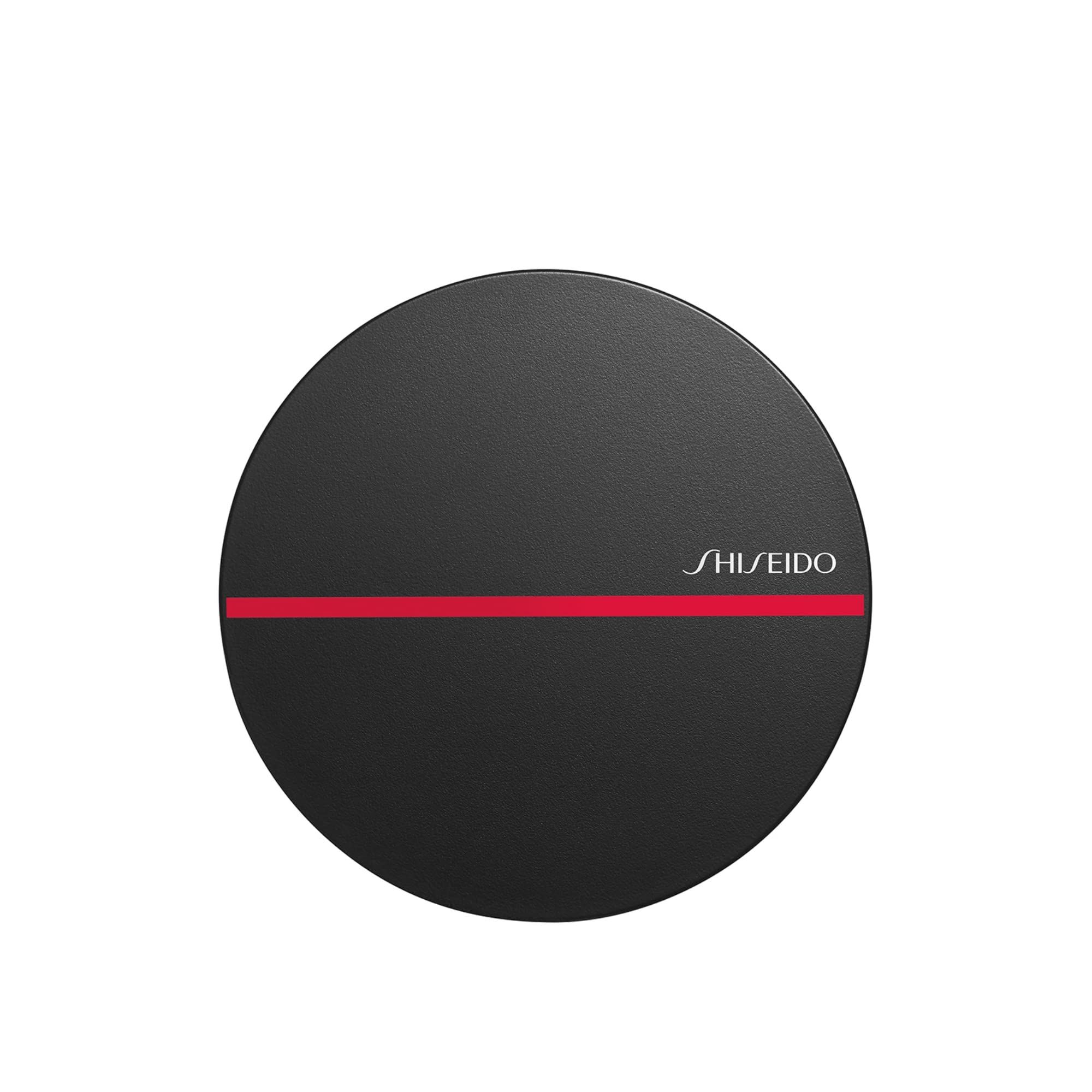Contenant rond noir avec ligne rouge et logo SHISEIDO. Couvercle fermé.