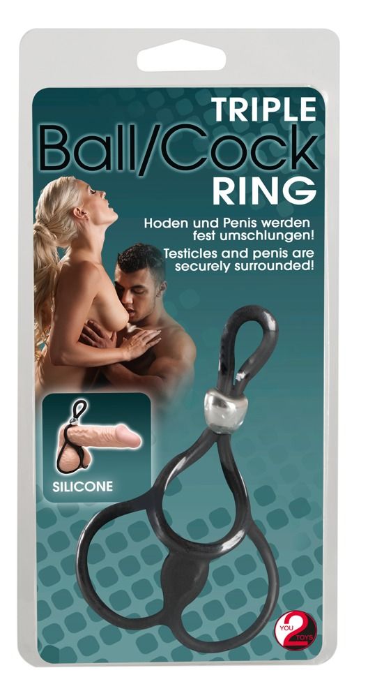 Emballage avec image du produit. Anneau noir avec pièce de jonction argentée. Texte: Triple Ball/Cock Ring.
