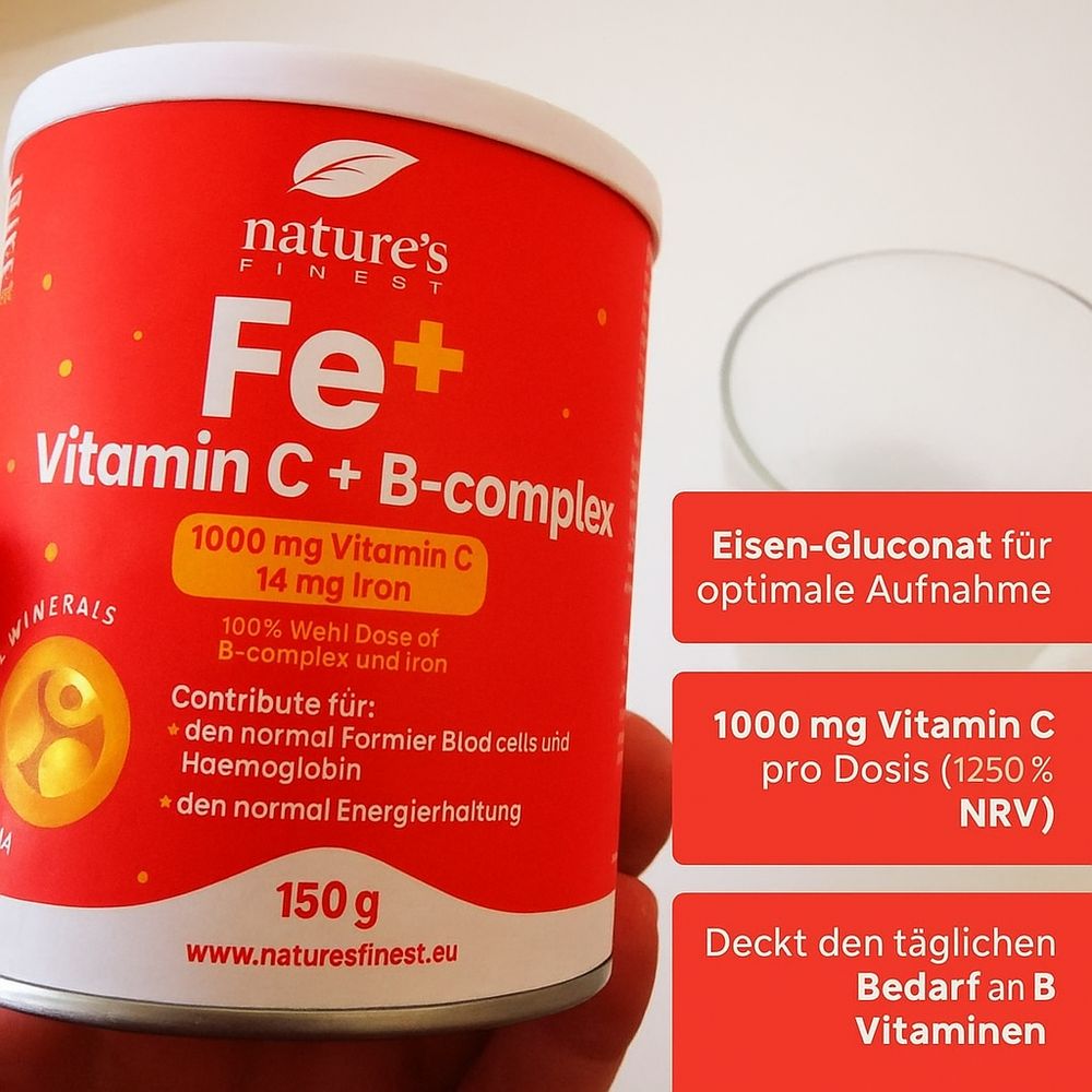 Boîte rouge "Nature's Finest Fe+ Vitamine C + B-Complexe". Contient 1000 mg vitamine C et 14 mg fer. Textes d'informations.