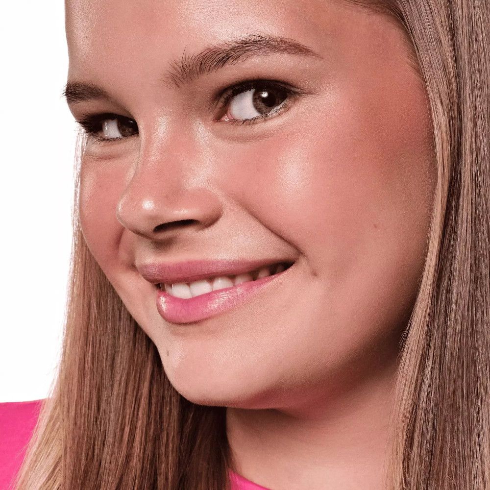 Portrait d'une jeune fille souriante avec du fard à joues sur les joues.