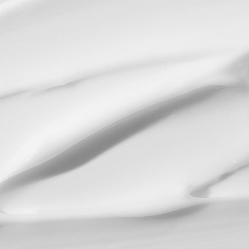 Close-up van crème oppervlak. Gladde, witte crème met golven.