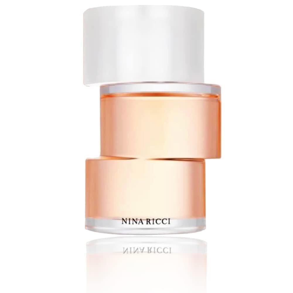 Parfumfles. Fles met transparante dop. Opschrift NINA RICCI en Premier Jour. Reflectie.