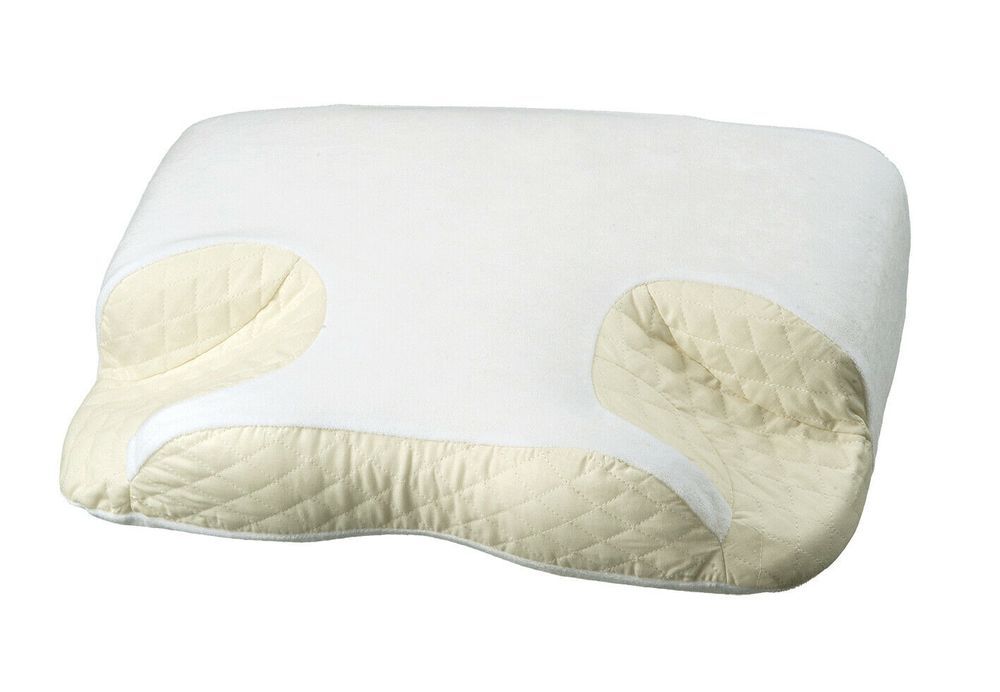 Oreiller CPAP beige à 6 zones. Forme rectangulaire avec découpes. Tissu matelassé sur les côtés.