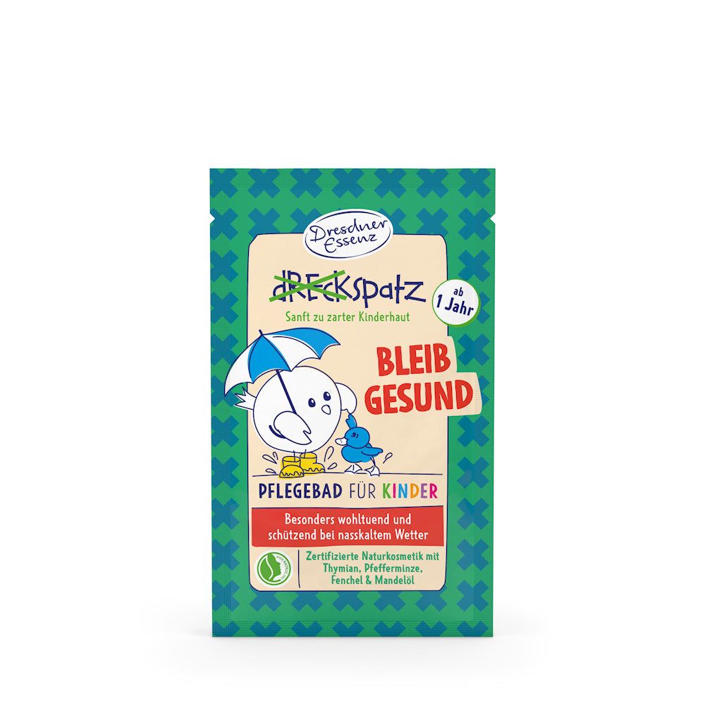 Emballage Dresdner Essenz Bain de soin pour enfants. Motif : oiseau avec parapluie. Texte : Bleib Gesund, à partir de 1 an.