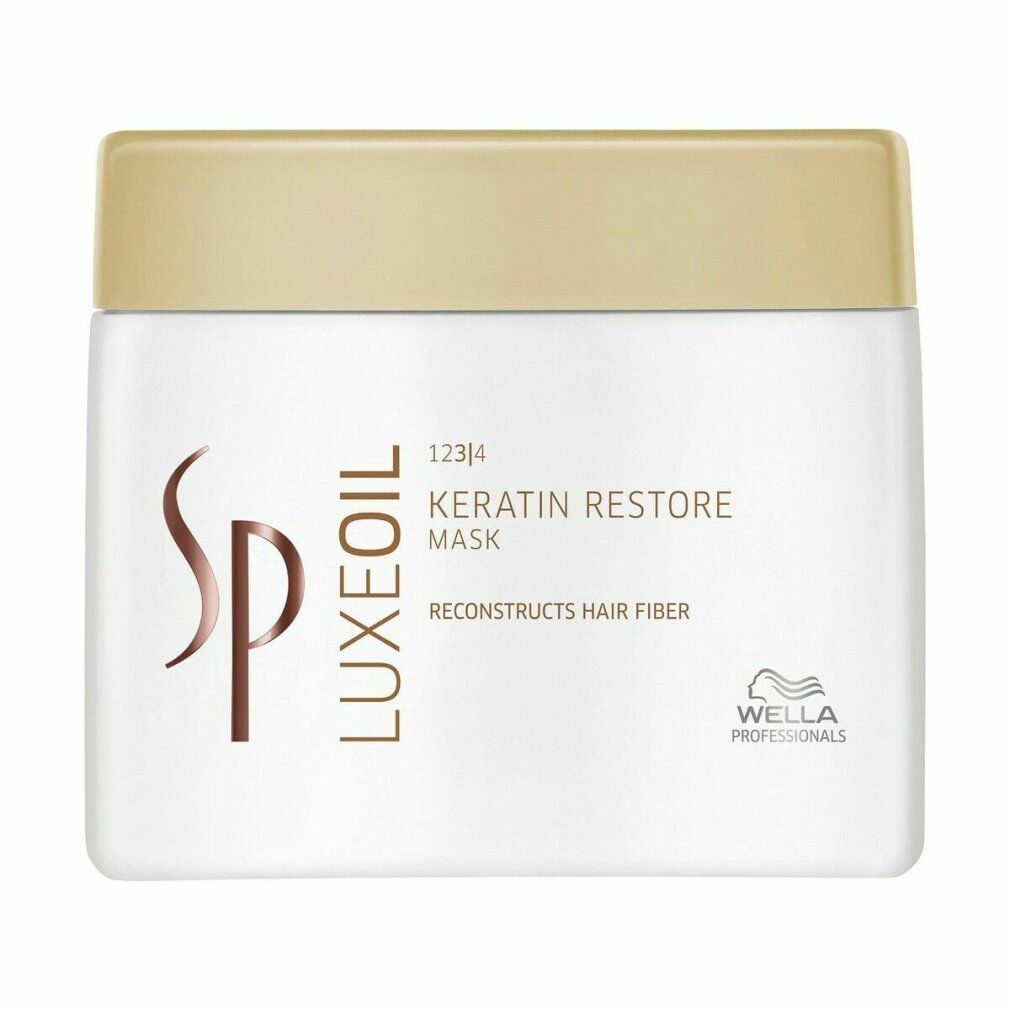 Pot blanc avec couvercle doré. Inscription : Keratin Restore Mask, Wella SP Luxeoil.